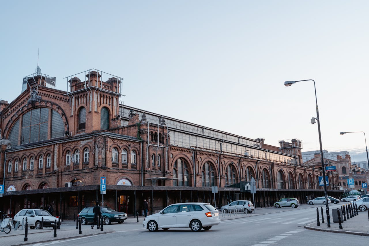 Historic urban building with classic design in city center, surrounded by street and traffic.